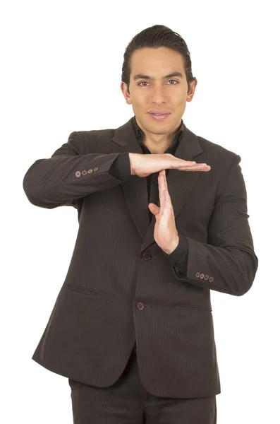 Handsome young man wearing a suit posing gesturing time out — Stock Photo, Image