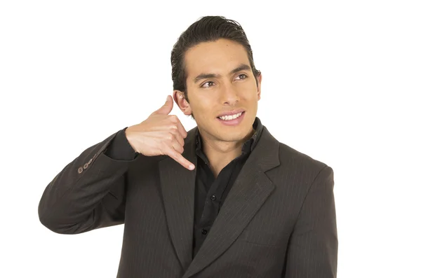 Handsome young man wearing a suit posing gesturing call me — Stock Photo, Image