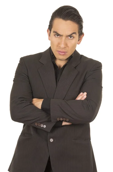 Handsome young man wearing a suit posing crossing arms angry — Stock Photo, Image