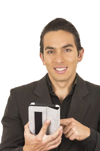 Handsome young man wearing a suit posing using tablet — Stock Photo, Image