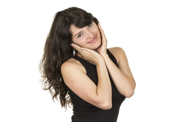 Beautiful young brunette woman wearing black top posing touching cheeks with hands — Stock Photo, Image