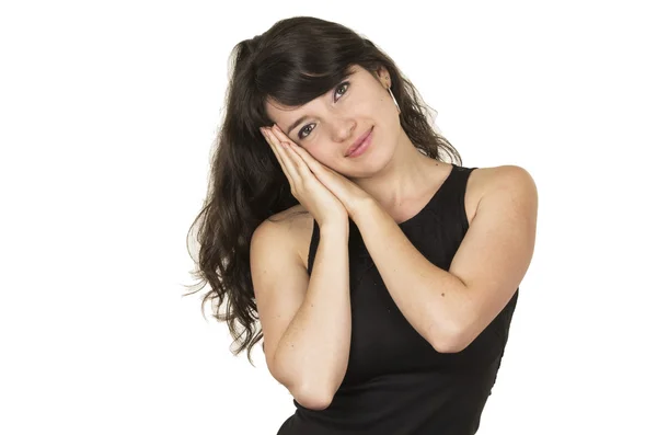 Beautiful young brunette woman wearing black top gesturing sleeping — Stock Photo, Image