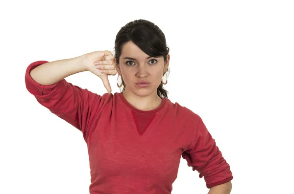 Menina bonita vestindo top vermelho posando segurando polegar para baixo gesto decepção — Fotografia de Stock