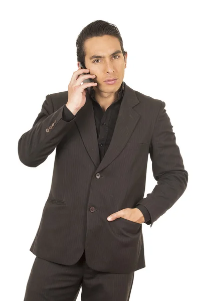 Handsome young man wearing a suit posing using cell phone mobile — Stock Photo, Image