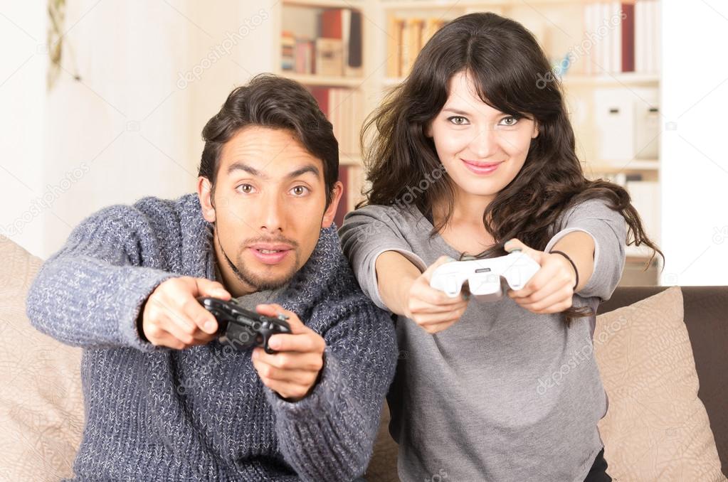young cute couple playing video games