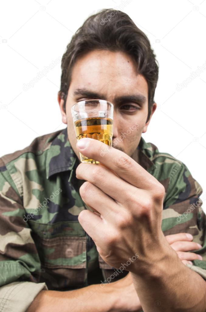 distraught military soldier veteran ptsd drinking a shot of liquor
