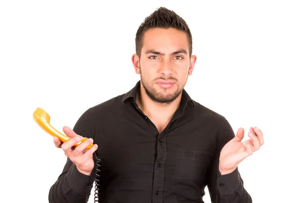 Closeup portrait of handsome hispanic man holding corded retro phone — Stock Photo, Image