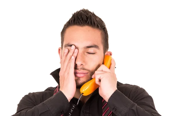 Closeup portrait of handsome hispanic man talking on corded retro phone — Stock Photo, Image