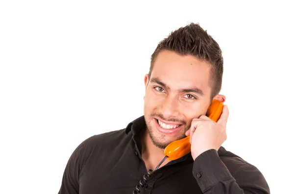 Closeup portrait of handsome hispanic man talking on corded retro phone — Stock Photo, Image