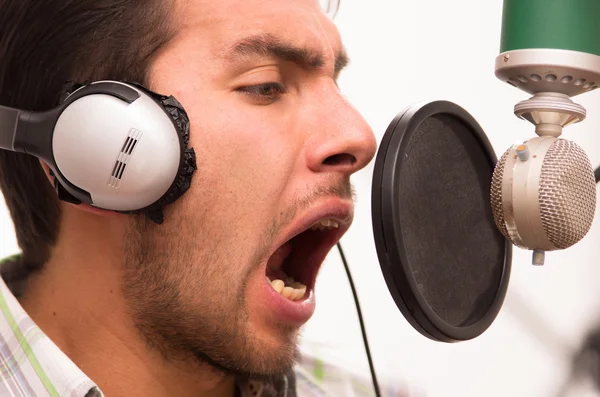 Pohledný muž zpívat v hudebním studiu — Stock fotografie
