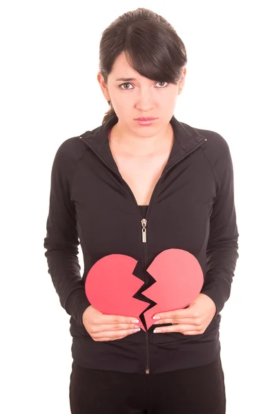 悲伤年轻漂亮的女孩拿着心碎的撕裂的红色心概念 — 图库照片