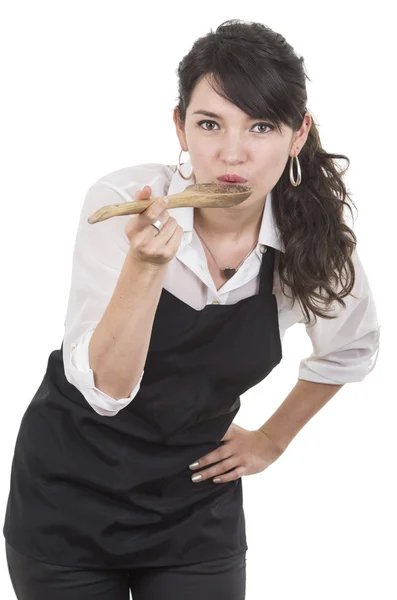 Jonge mooie vrouwelijke chef-kok zwart schort dragen Stockfoto