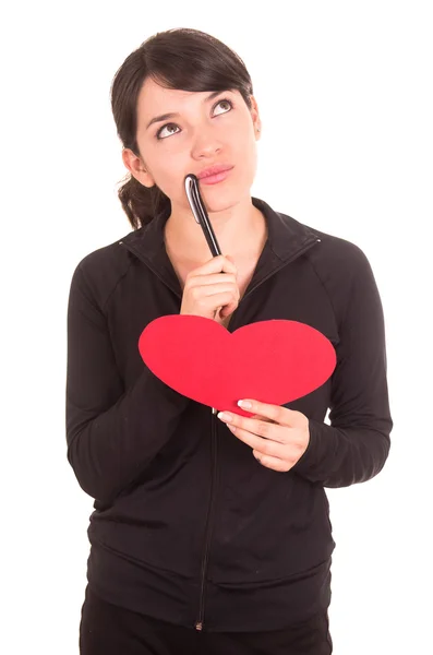 Beautiful young latin happy girl holding red paper heart and a pen — Stock Photo, Image