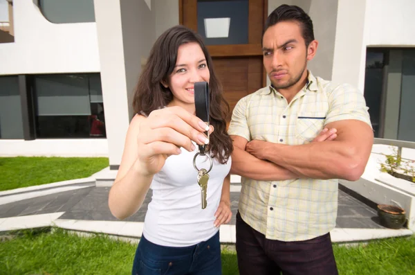 Happy couple holding key to their new house — Stock Photo, Image