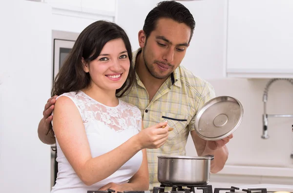 Happy attractive couple cooking together — Stock Photo, Image