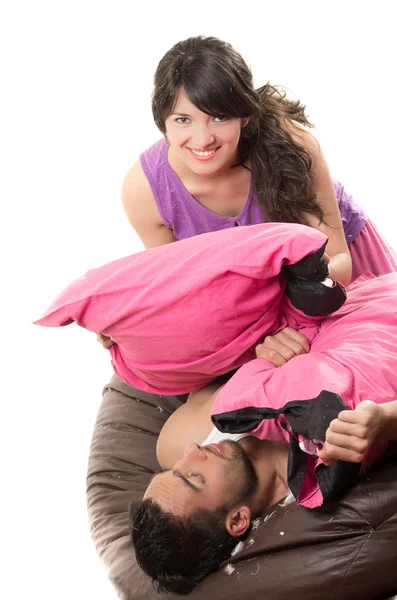 Cute attractive couple having a pillow fight — Stock Photo, Image