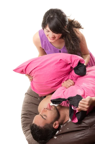 Cute attractive couple having a pillow fight — Stock Photo, Image