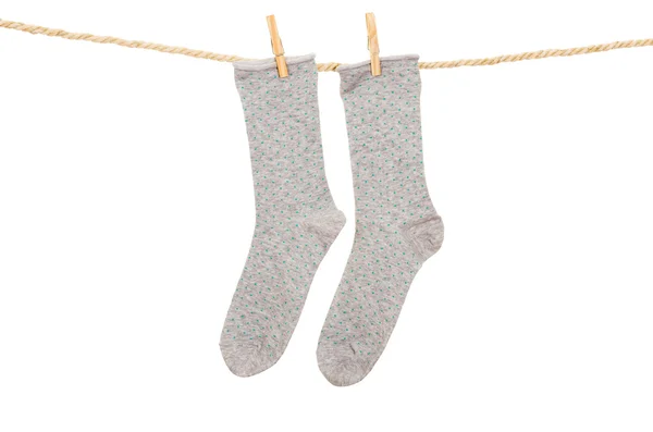 socks hanging on a rope clothesline