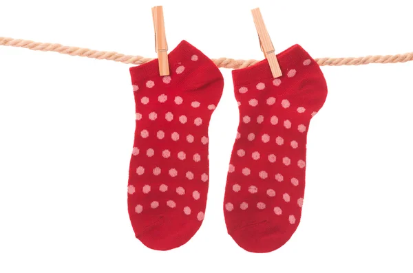 Red socks hanging on a rope clothesline — Stock Photo, Image