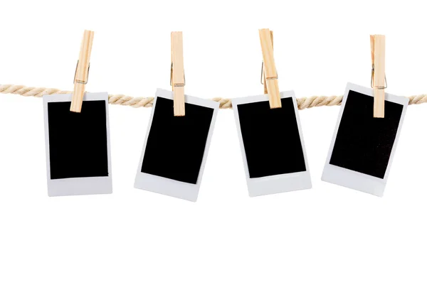 Instant photographs hanging on a rope clothesline — Stock Photo, Image
