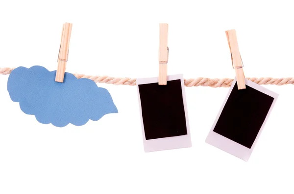 Instant photographs and cloud shape hanging on a rope clothesline — Stock Photo, Image