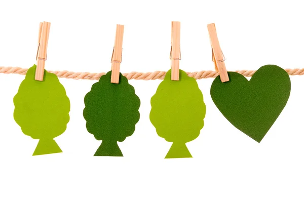 Green trees and heart paper shapes hanging on a rope clothesline — Stock Photo, Image