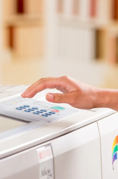 Hand of a person using copy machine — Stock Photo, Image