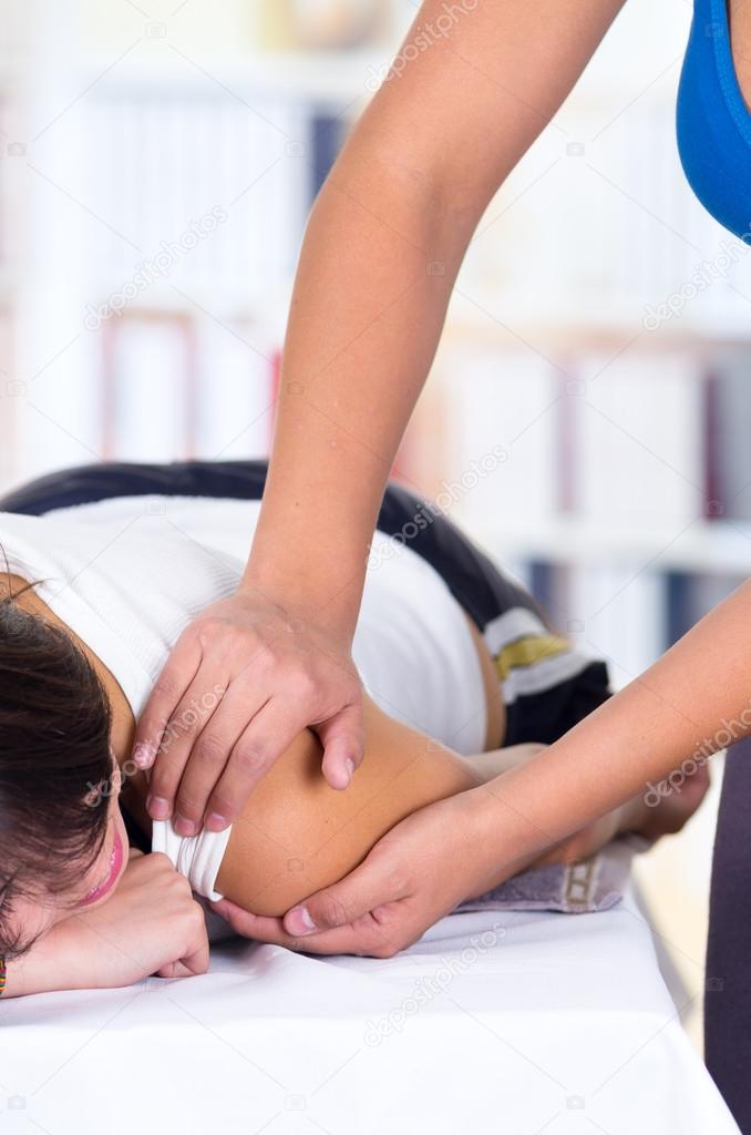 woman lying while getting a massage concept of physiotherapy