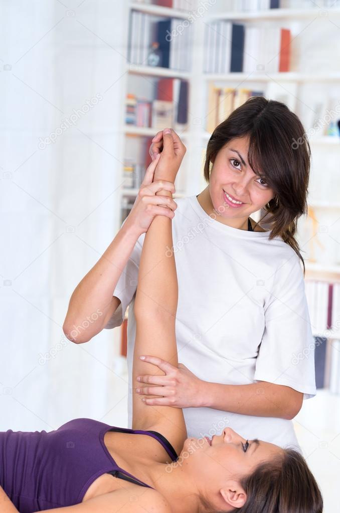 woman lying while getting a massage concept of physiotherapy