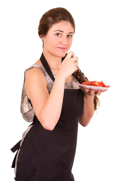 Vacker ung flicka äter färska tomater — Stockfoto