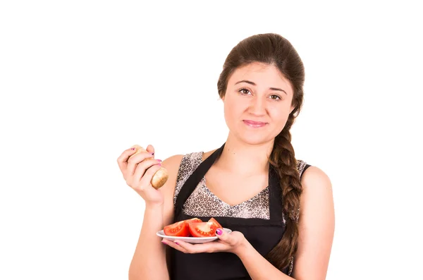 Beautiful young girl eating fresh tomatoes — Stock Photo, Image