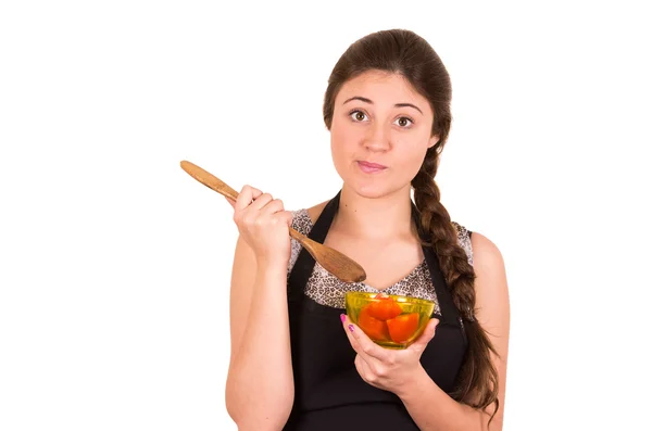 Beautiful young girl eating fresh tomatoes — Stock Photo, Image