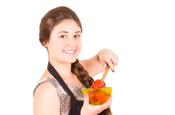 Beautiful young girl eating fresh tomatoes — Stock Photo, Image