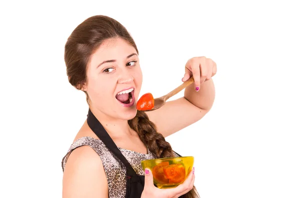 Beautiful young girl eating fresh tomatoes — Stock Photo, Image