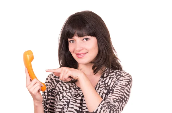 Mooie jonge vrouw via retro oranje telefoon — Stockfoto