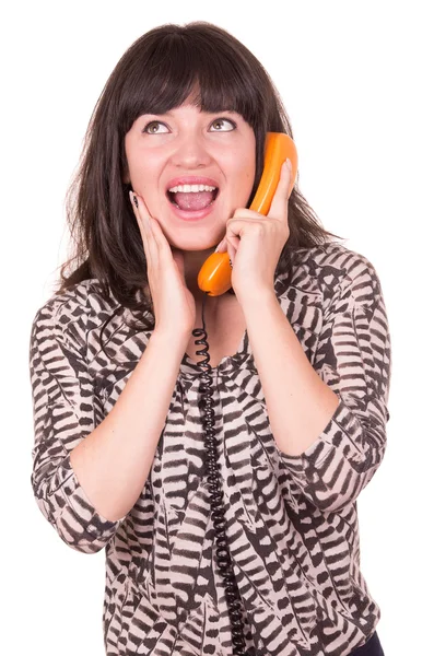 Mooie jonge vrouw via retro oranje telefoon — Stockfoto