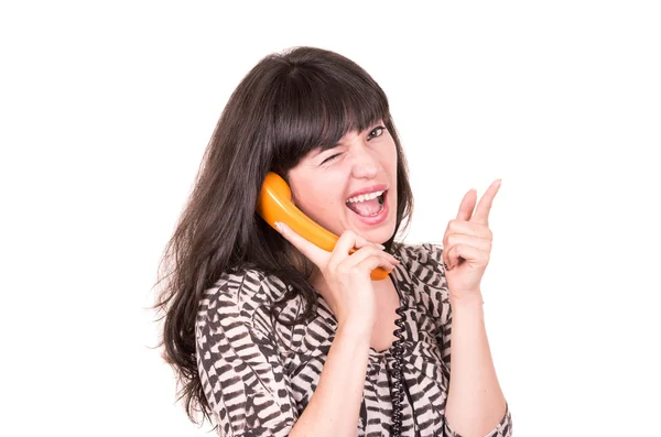 Beautiful young woman using retro orange telephone — Stock Photo, Image