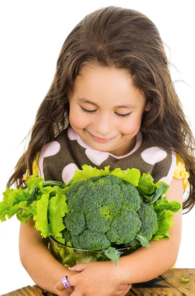 Adorable healthy little girl holding salad bowl with broccoli and lettuce — Stock Photo, Image