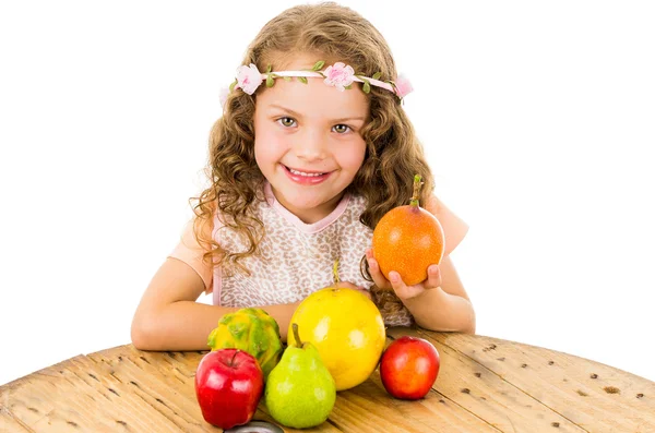 Cute little preschooler girl with fruits on the table — Stock Photo, Image