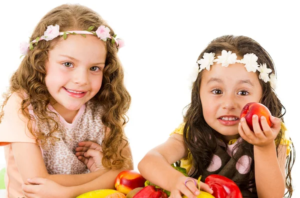 Beautiful healthy little girls holding delicious fresh fruits and vegetables — Stock Photo, Image