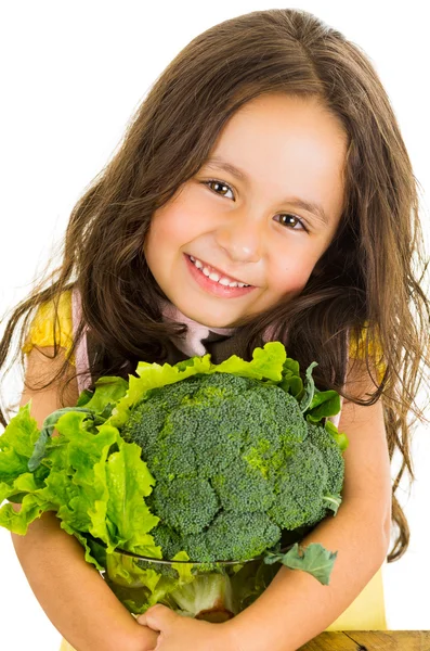 Adorable healthy little girl holding salad bowl with broccoli and lettuce — Stock Photo, Image