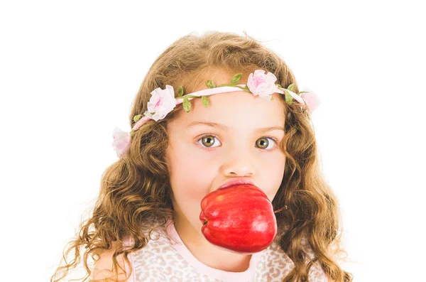 Beautiful healthy little curly girl enjoying eating a red pepper capsicum — Stock Photo, Image