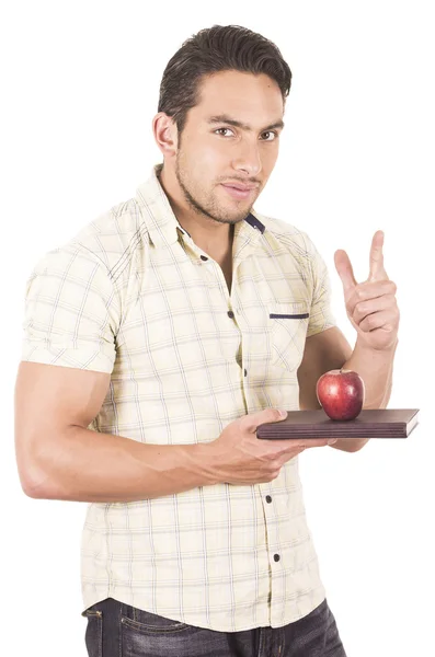 Joven feliz maestro masculino sosteniendo cuaderno y manzana roja — Foto de Stock