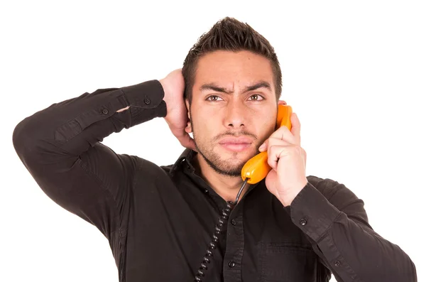 Nahaufnahme Porträt eines hübschen hispanischen Mannes, der auf schnurgebundenem Retro-Telefon spricht — Stockfoto