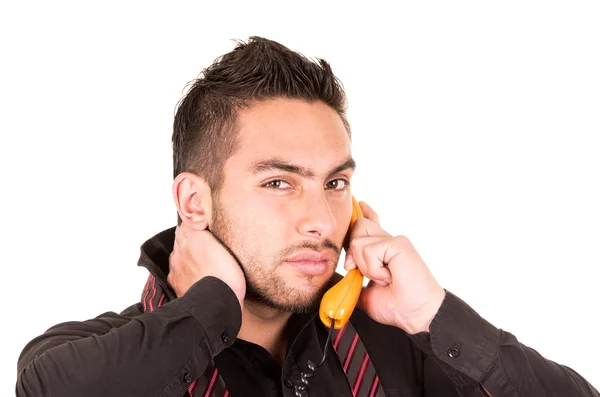 Closeup portrait of handsome hispanic man talking on corded retro phone — Stock Photo, Image