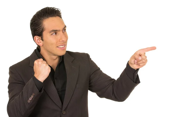 Handsome young man wearing a suit posing pointing to the side — Stock Photo, Image