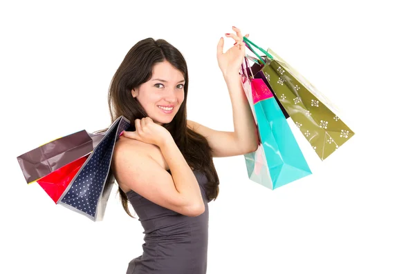 Vacker ung brunett leende kvinna shopping anläggning väskor — Stockfoto