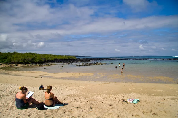 Oidentifierade turister njuter solig dag på stranden i vackra Santa Cruz island, Galapagos — Stockfoto