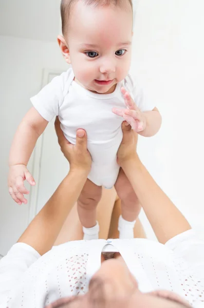 Closeup portrait of sweet baby boy being held by her mother — Stock Photo, Image