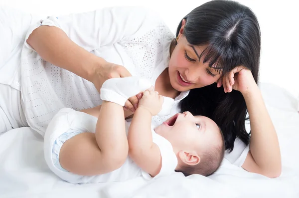 Beautiful young mom staring at her small cute baby — Stock Photo, Image